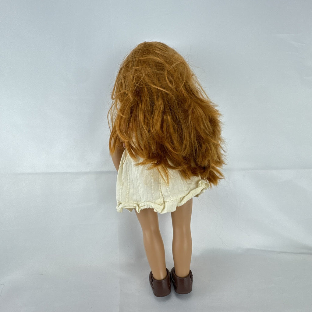 Battat Our Generation 18-inch doll with auburn hair and green eyes wearing cream ruffle dress and pink shrug