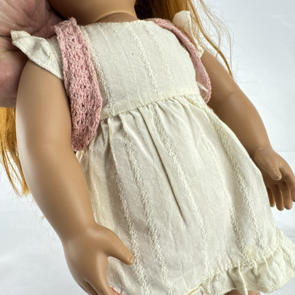 Battat Our Generation 18-inch doll with auburn hair and green eyes wearing cream ruffle dress and pink shrug