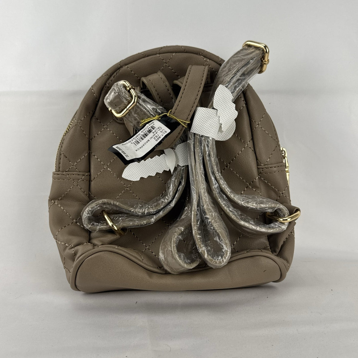 bebe Julia mini backpack purse in taupe quilted faux leather with gold chain trim and original tags