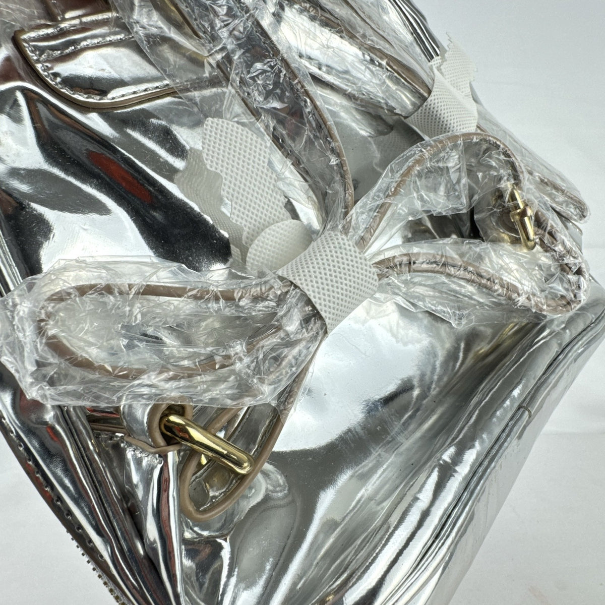 Bebe Kylie mini backpack in metallic silver faux leather with gold-tone hardware