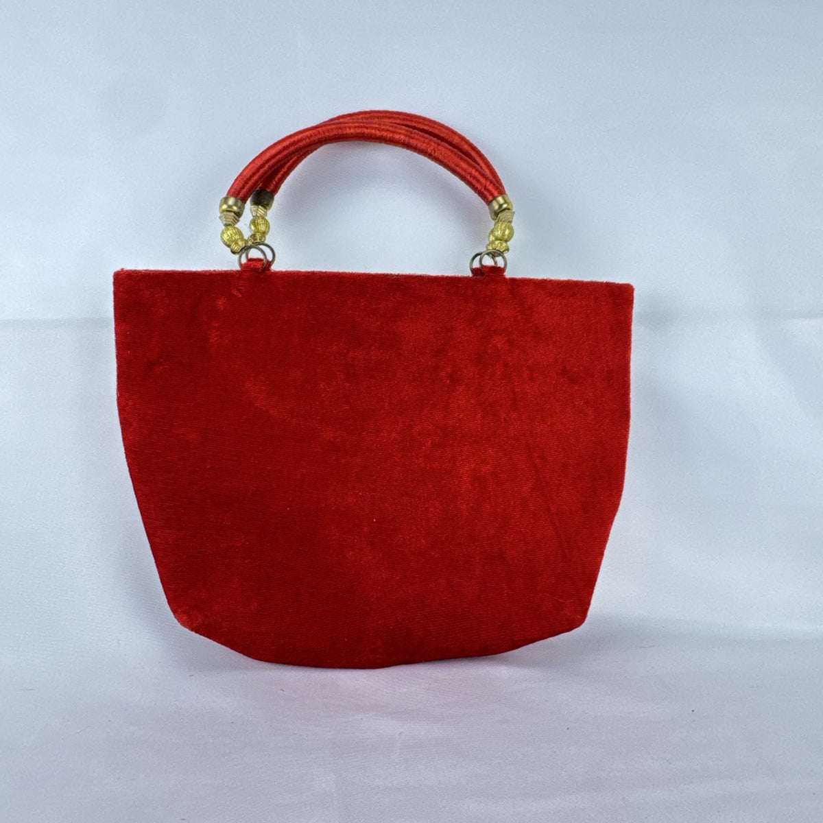 Red velvet top handle evening handbag with ornate gold-tone rhinestone and bead embellishments