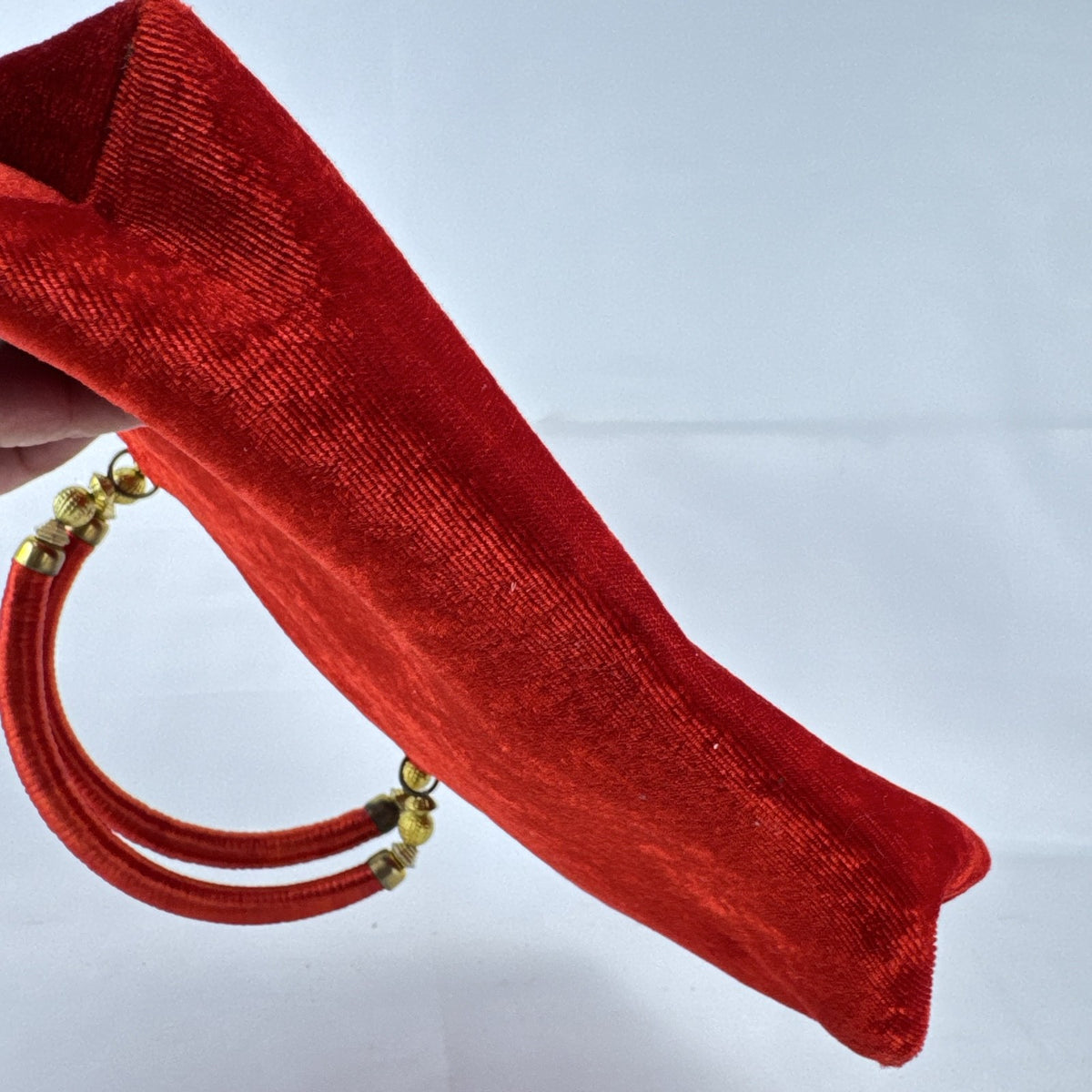Red velvet top handle evening handbag with ornate gold-tone rhinestone and bead embellishments