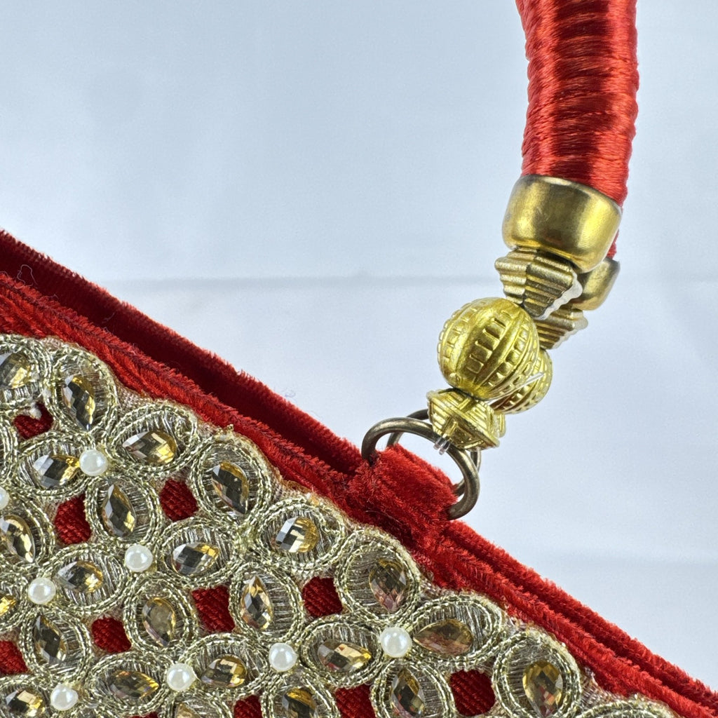 Red velvet top handle evening handbag with ornate gold-tone rhinestone and bead embellishments