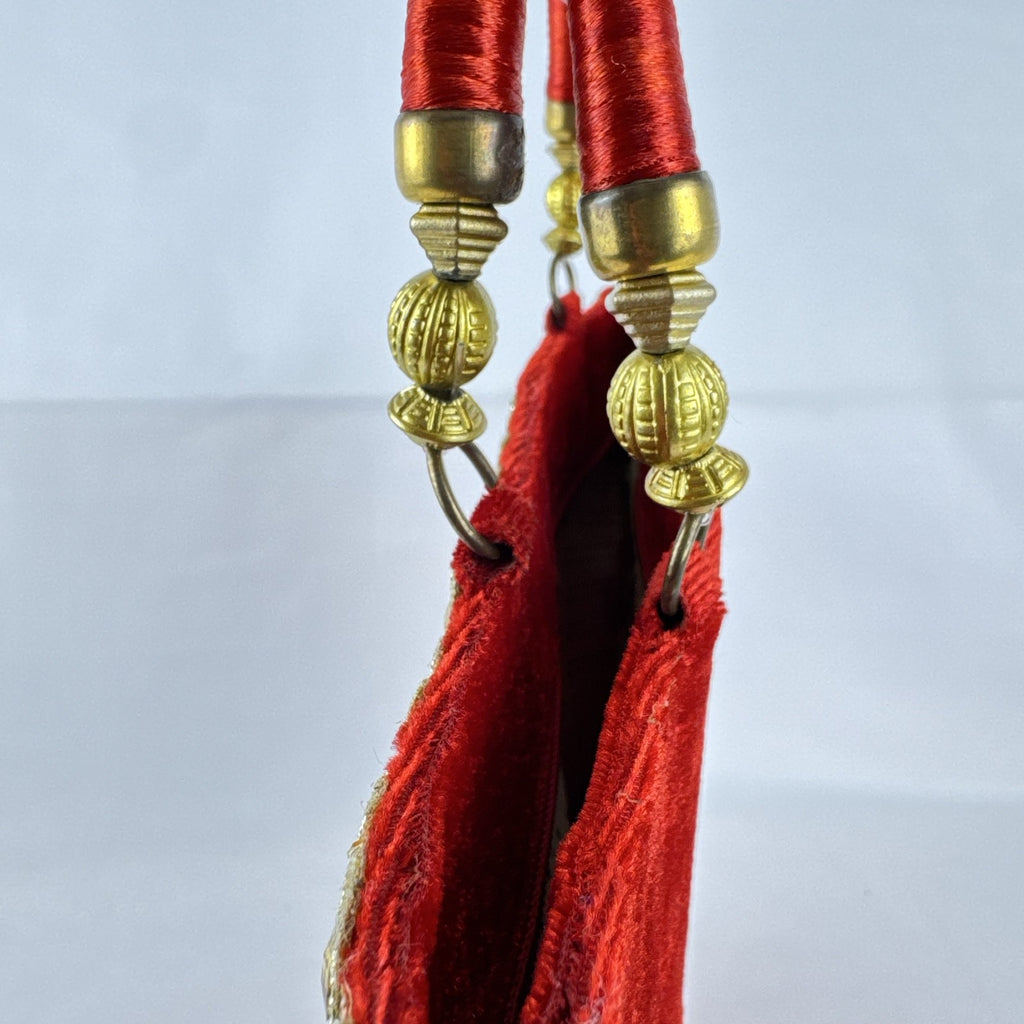 Red velvet top handle evening handbag with ornate gold-tone rhinestone and bead embellishments