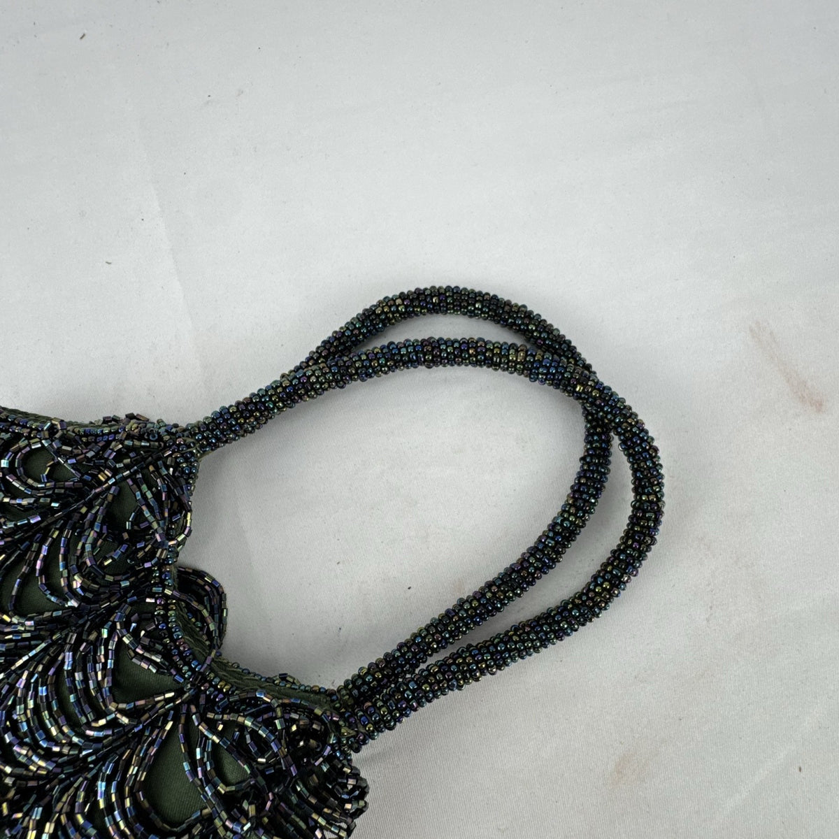 Iridescent oil slick beaded mini evening bag in olive green satin with dual beaded top handles