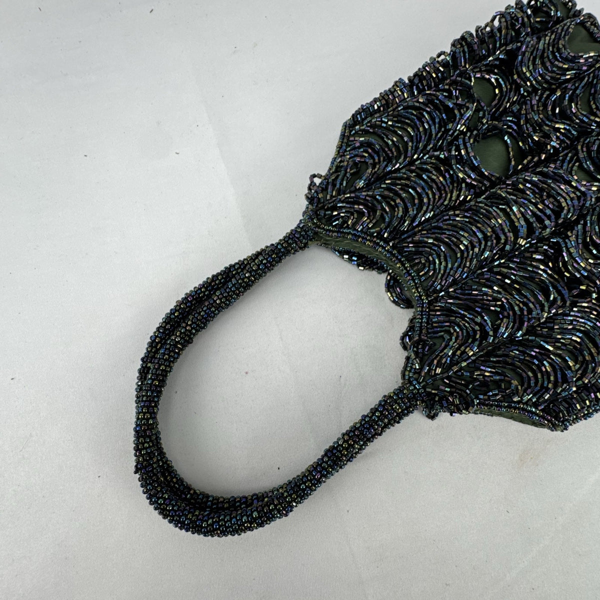 Iridescent oil slick beaded mini evening bag in olive green satin with dual beaded top handles