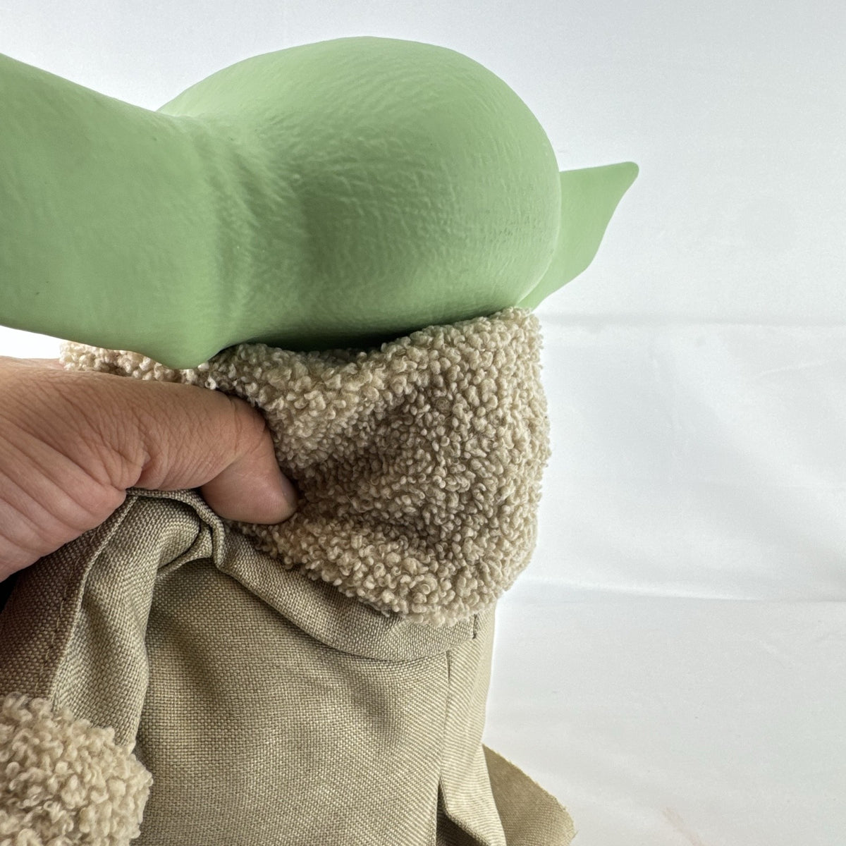 Mattel Star Wars Grogu 11-inch plush figure with sculpted vinyl head and tan faux-shearling robe