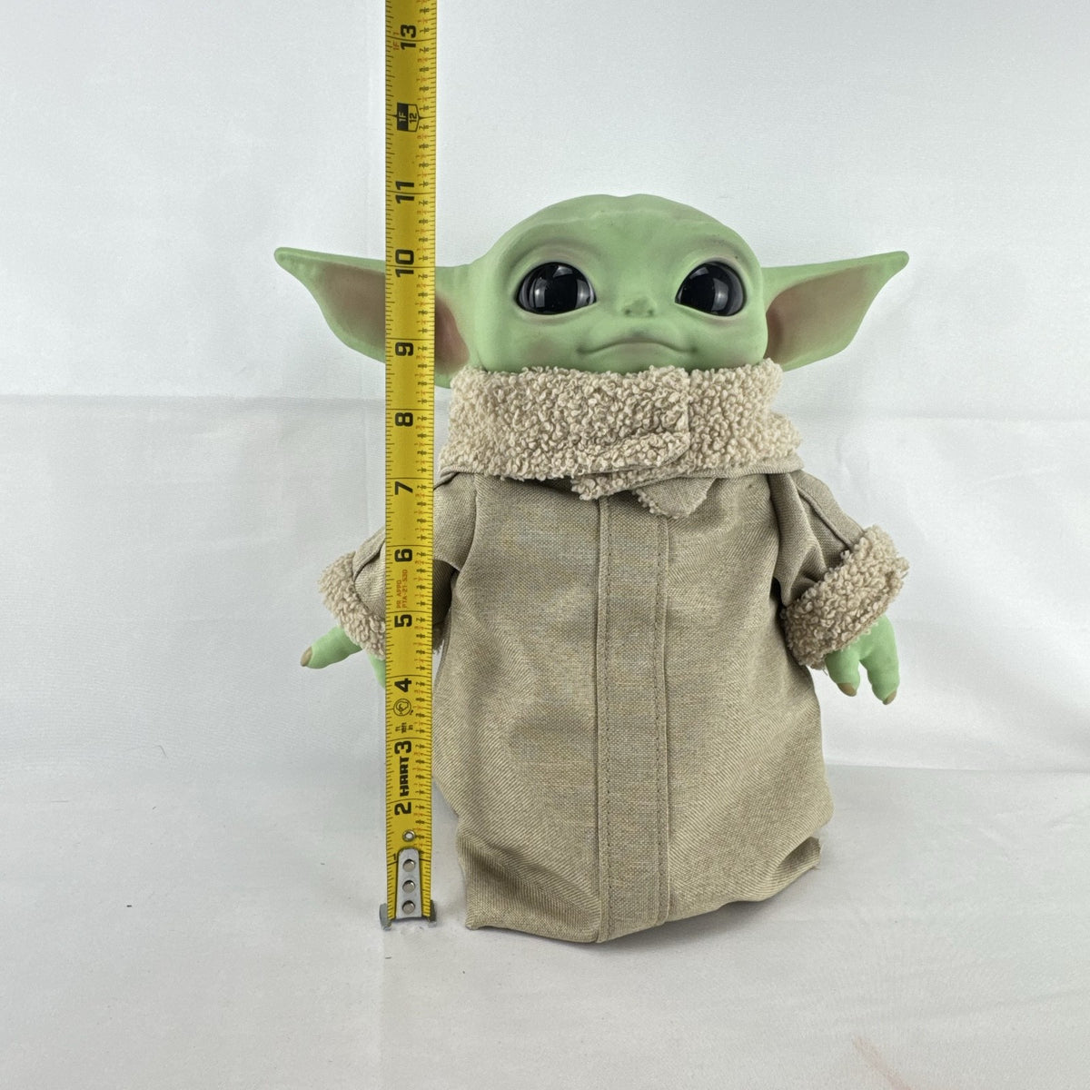 Mattel Star Wars Grogu 11-inch plush figure with sculpted vinyl head and tan faux-shearling robe
