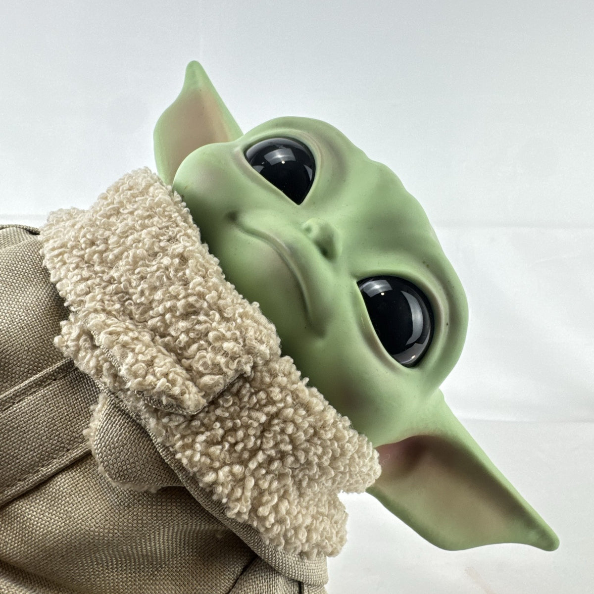 Mattel Star Wars Grogu 11-inch plush figure with sculpted vinyl head and tan faux-shearling robe