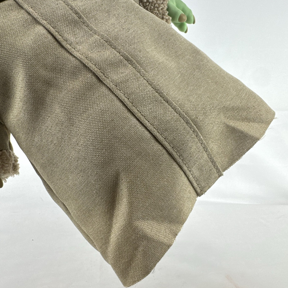 Mattel Star Wars Grogu 11-inch plush figure with sculpted vinyl head and tan faux-shearling robe