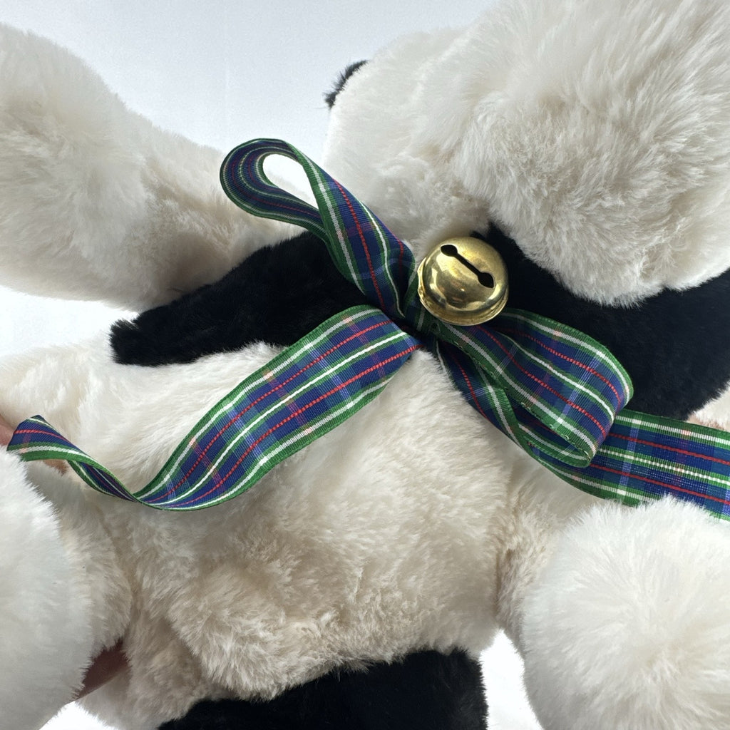 Star Gifts 13-inch black and white Holstein cow plush wearing a green plaid ribbon and jingle bell