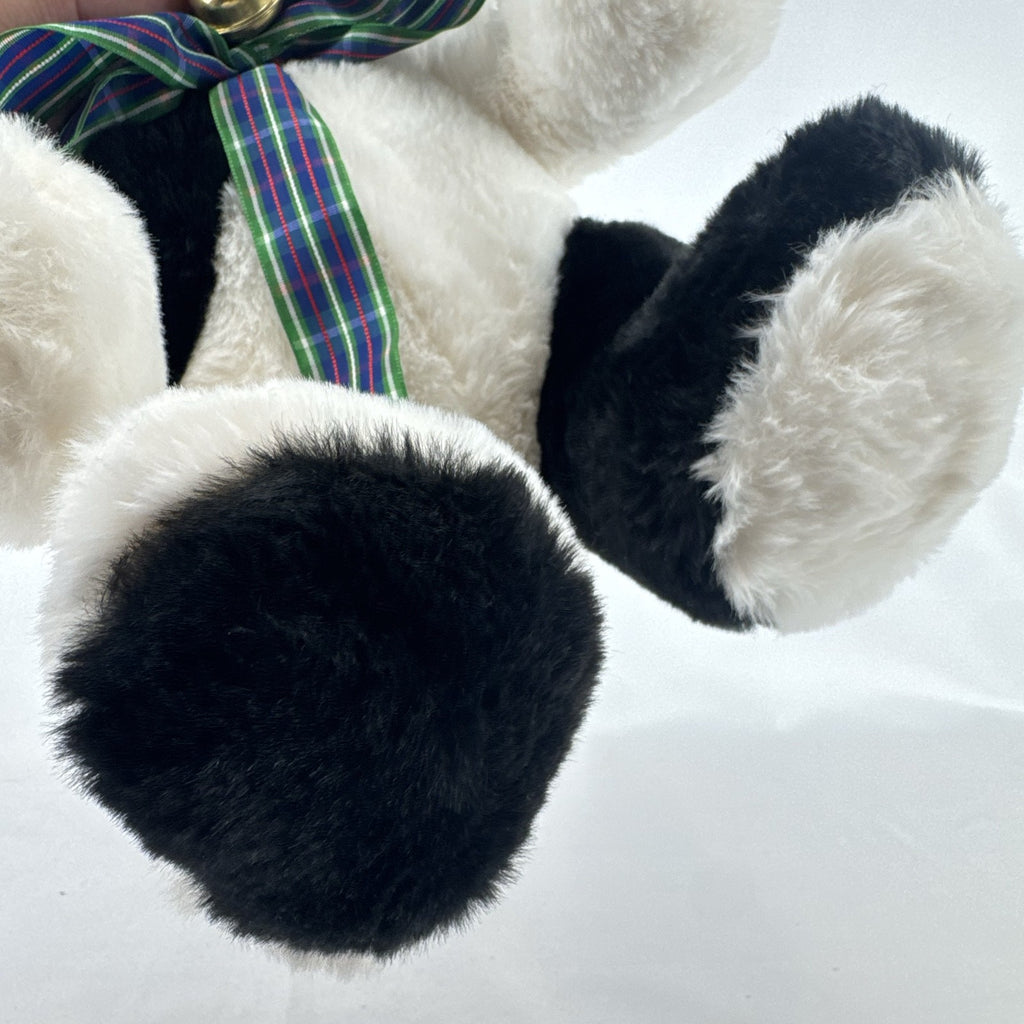 Star Gifts 13-inch black and white Holstein cow plush wearing a green plaid ribbon and jingle bell
