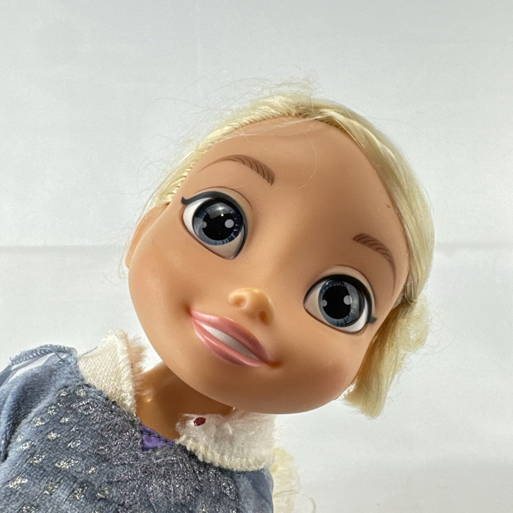 JAKKS Pacific Disney Frozen Elsa 13-inch toddler doll wearing blue winter dress with faux fur trim