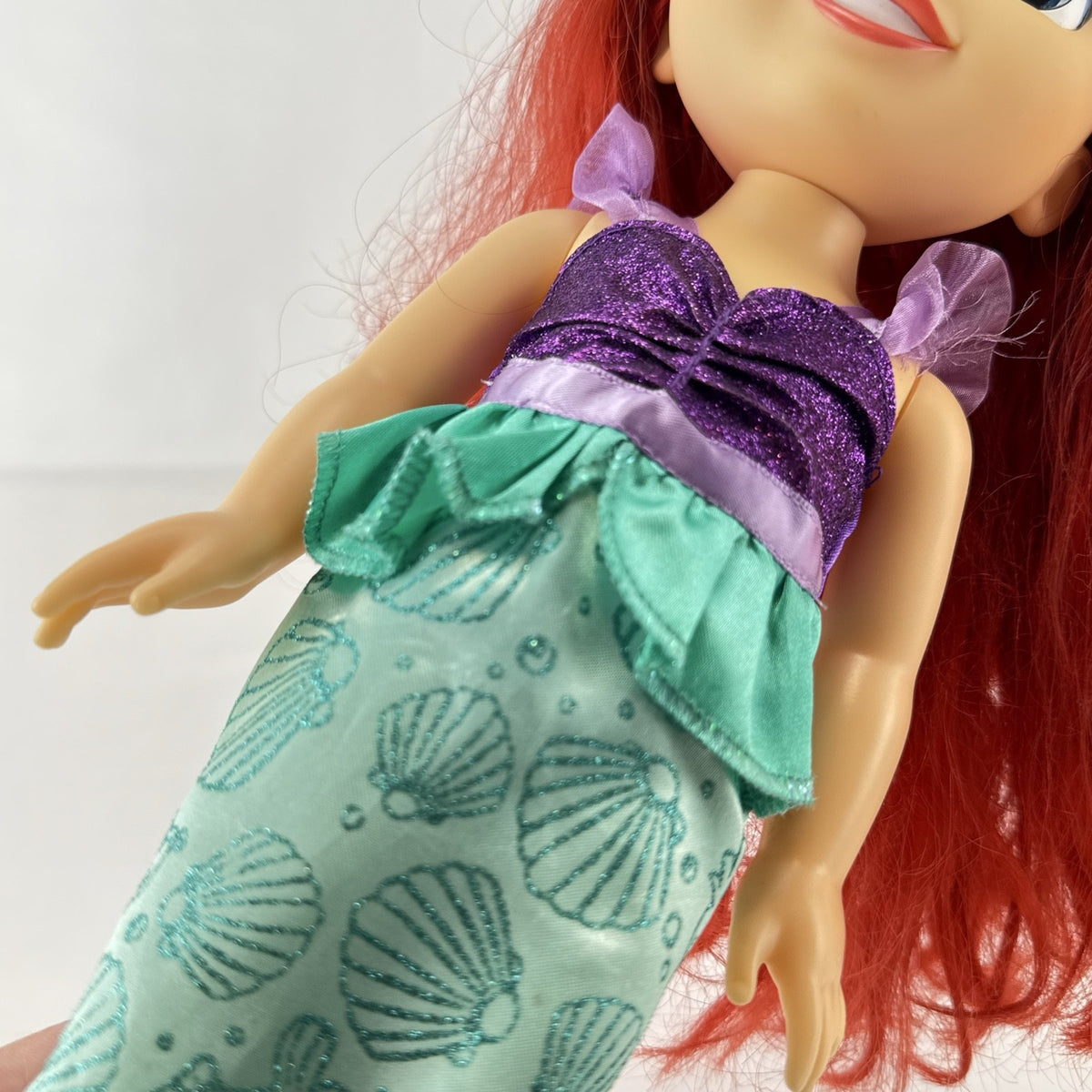 Disney Princess Ariel 13-inch vinyl toddler play doll wearing teal and purple mermaid dress