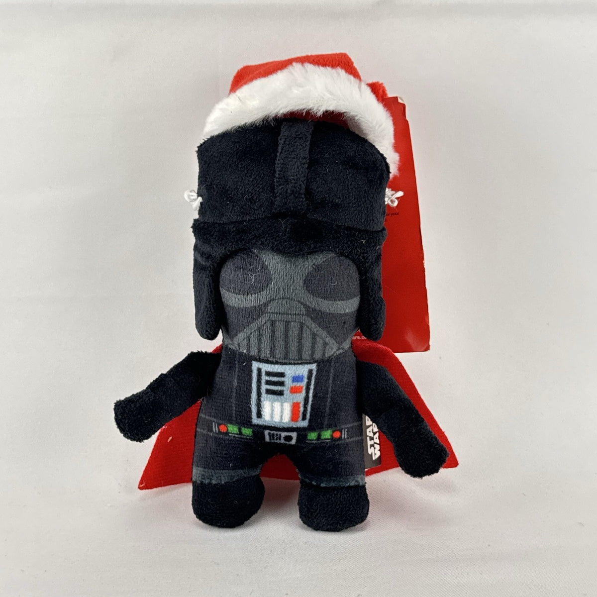 Star Wars holiday Darth Vader plush squeaker dog toy wearing a red Santa hat
