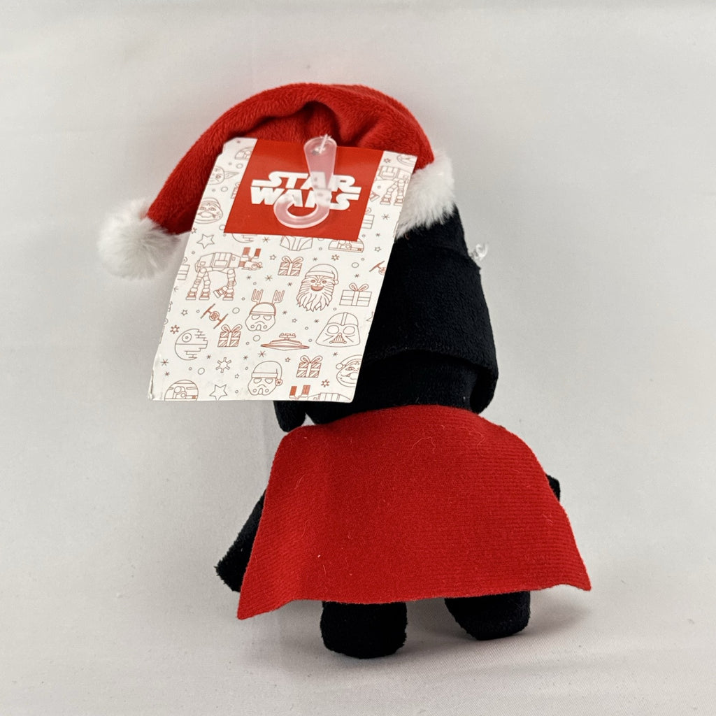 Star Wars holiday Darth Vader plush squeaker dog toy wearing a red Santa hat