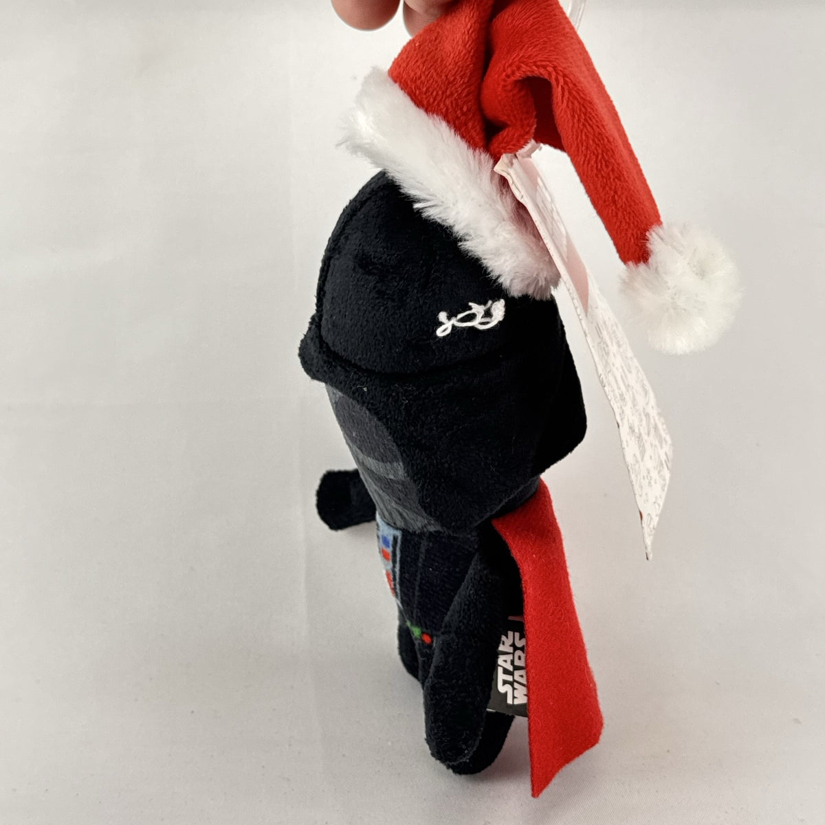Star Wars holiday Darth Vader plush squeaker dog toy wearing a red Santa hat