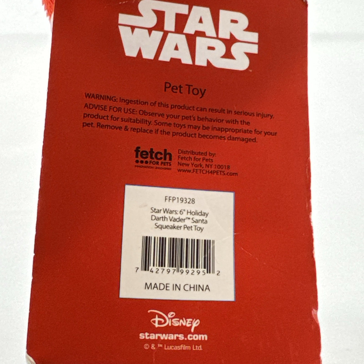 Star Wars holiday Darth Vader plush squeaker dog toy wearing a red Santa hat