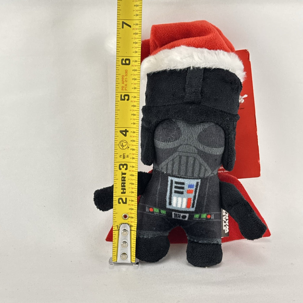 Star Wars holiday Darth Vader plush squeaker dog toy wearing a red Santa hat