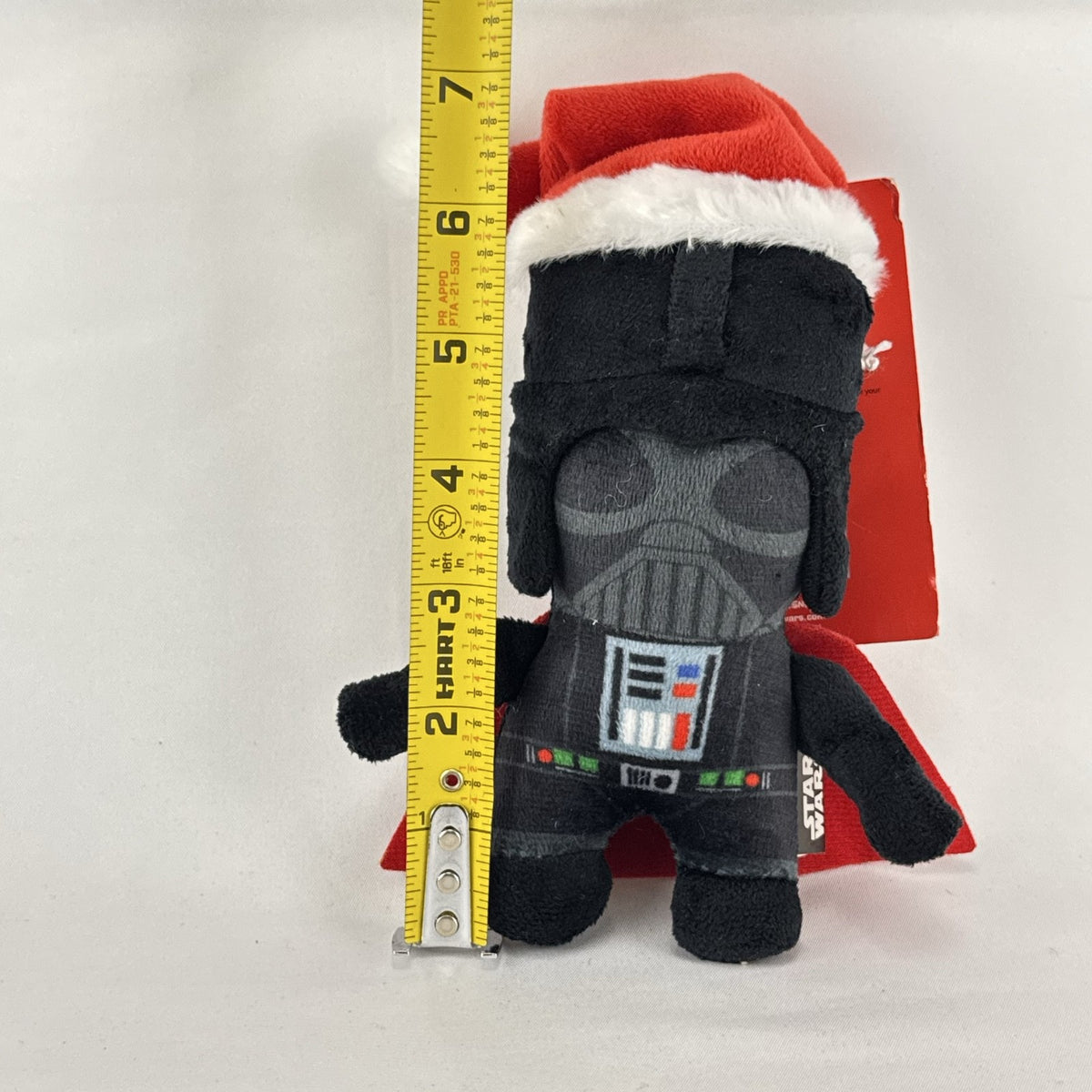 Star Wars holiday Darth Vader plush squeaker dog toy wearing a red Santa hat
