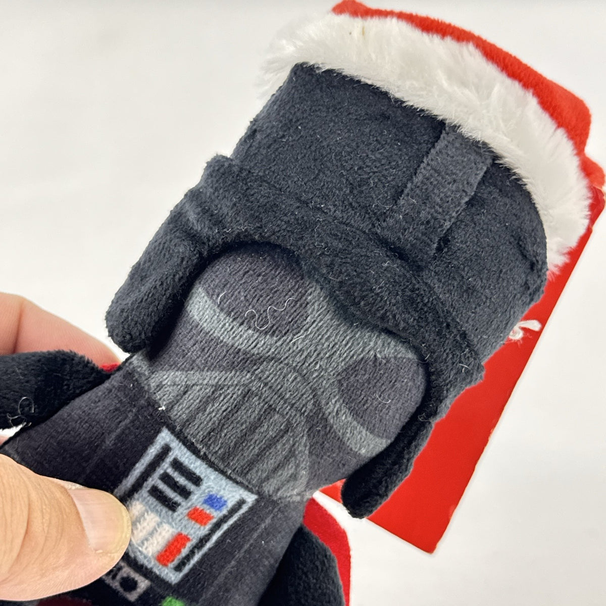 Star Wars holiday Darth Vader plush squeaker dog toy wearing a red Santa hat