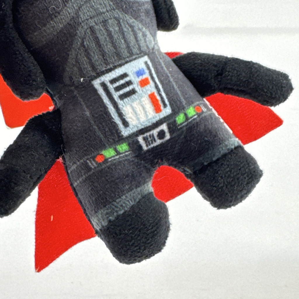 Star Wars holiday Darth Vader plush squeaker dog toy wearing a red Santa hat