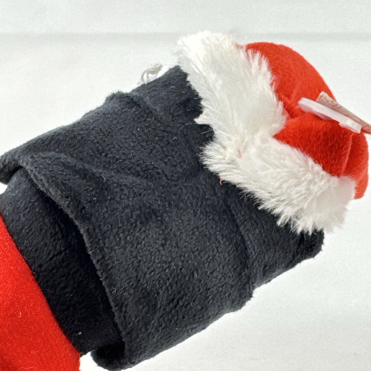 Star Wars holiday Darth Vader plush squeaker dog toy wearing a red Santa hat