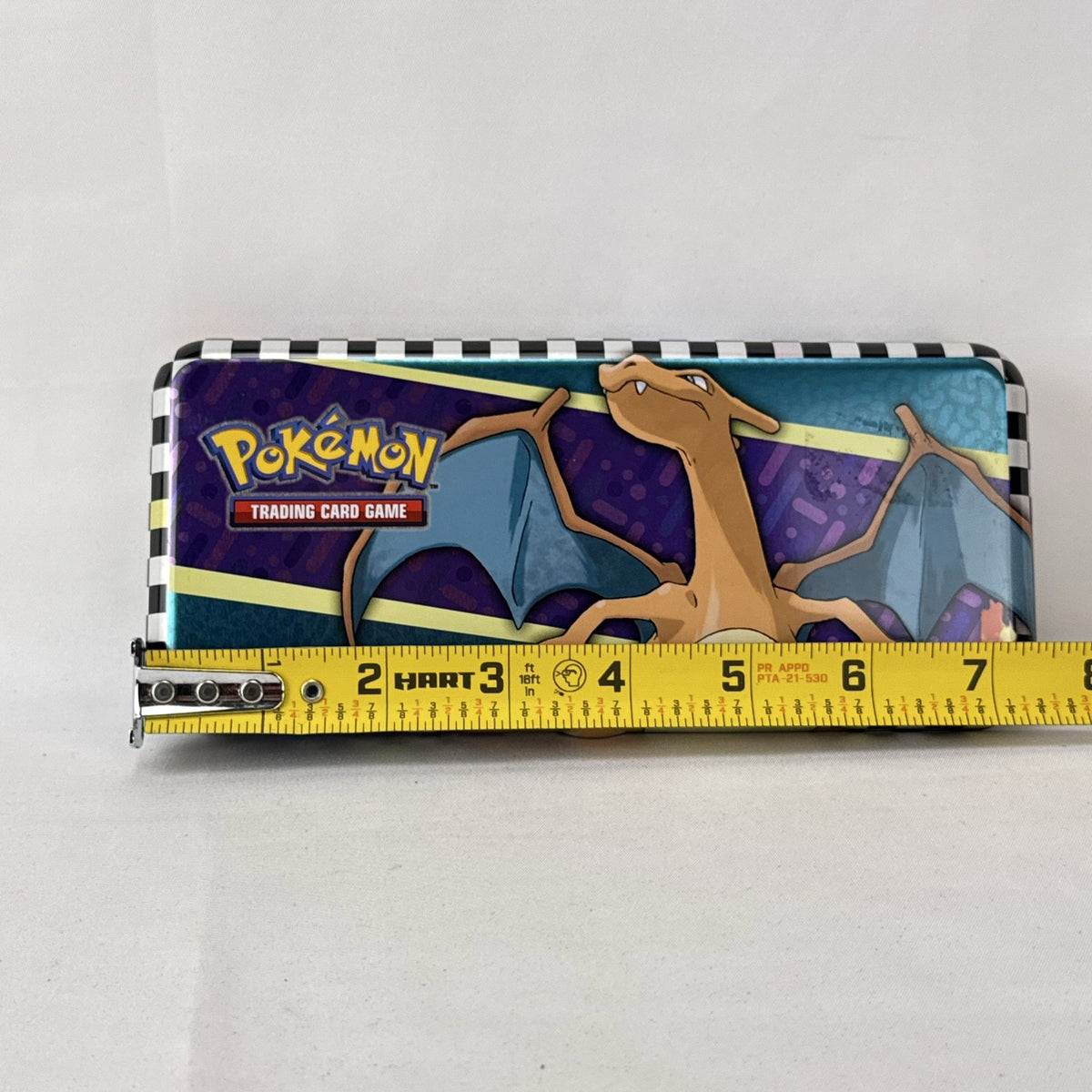 Pokémon 2024 embossed metal pencil tin featuring Charizard, Koraidon, and Miraidon