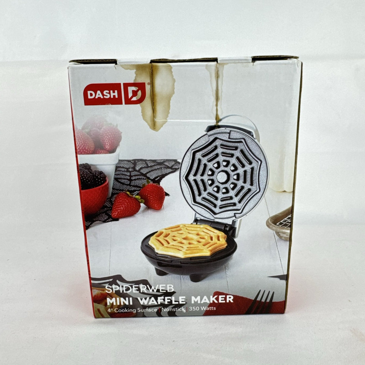 White Dash 4-inch mini waffle maker featuring an embossed Halloween spiderweb plate
