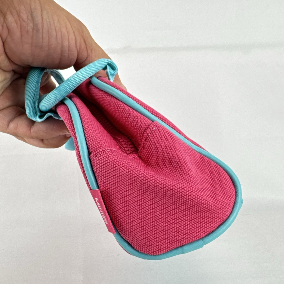 Miniso Barbie 65th Anniversary pink canvas mini duffle makeup bag with teal trim and top handles
