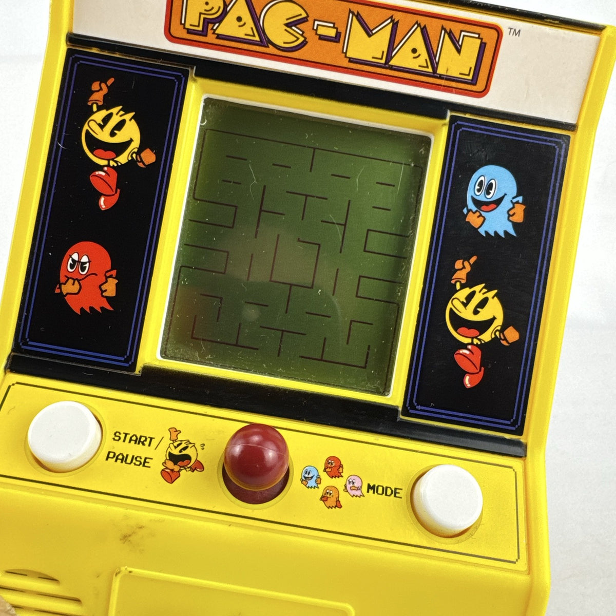 Basic Fun Pac-Man mini arcade cabinet handheld electronic game in yellow with LCD screen