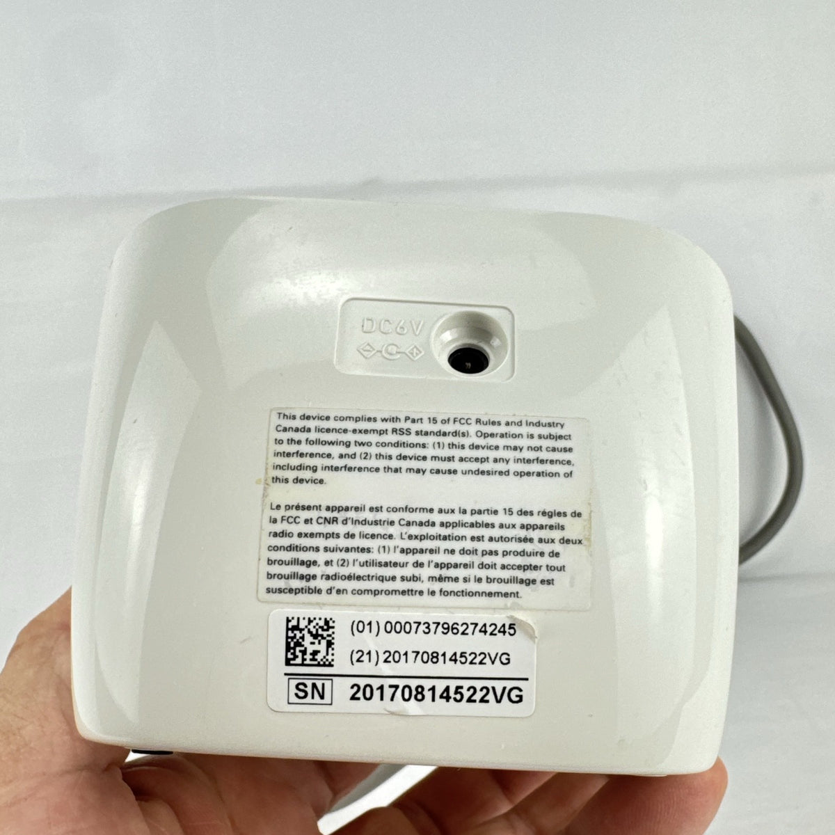 White Omron upper arm blood pressure monitor with digital LCD display and adjustable wide fabric cuff