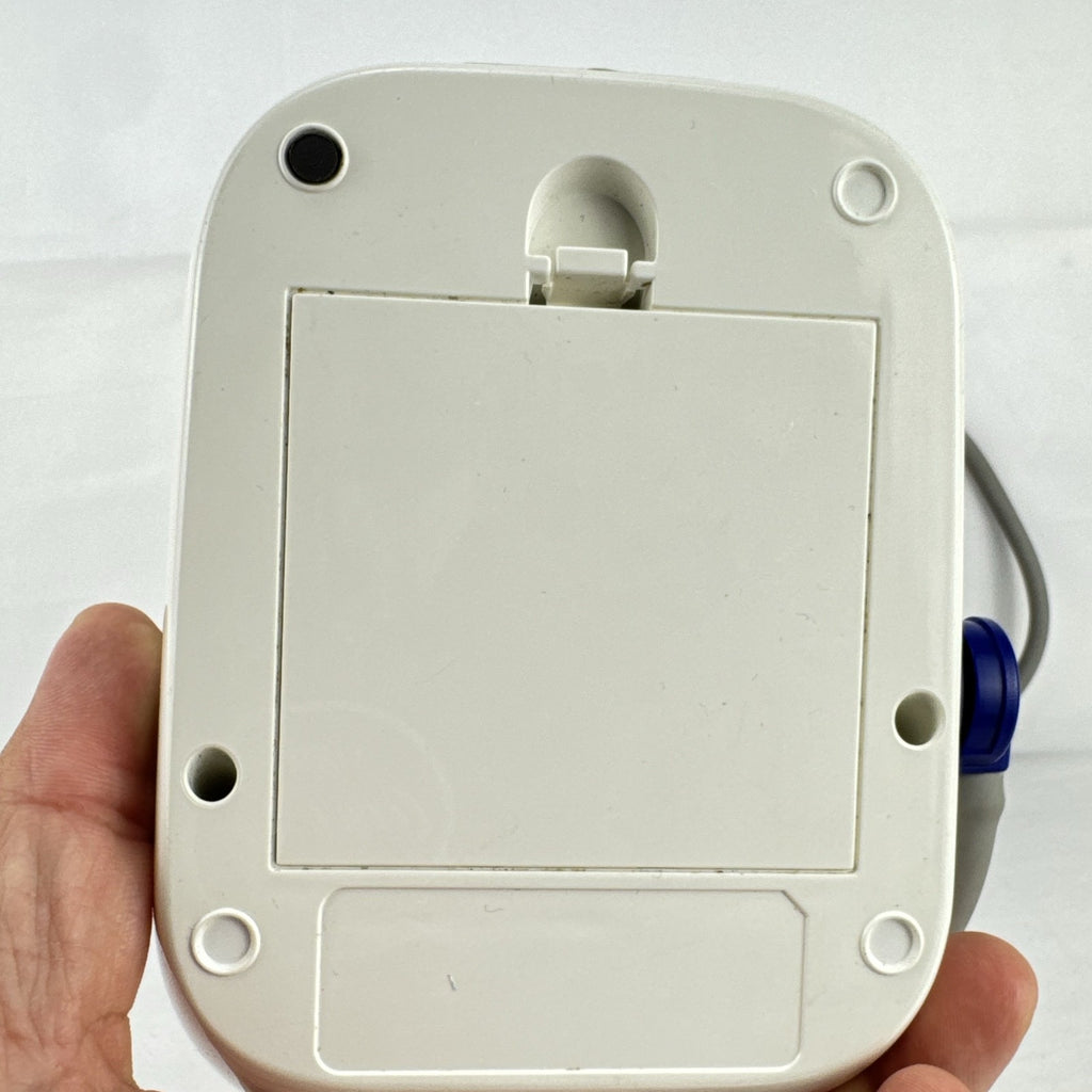 White Omron upper arm blood pressure monitor with digital LCD display and adjustable wide fabric cuff