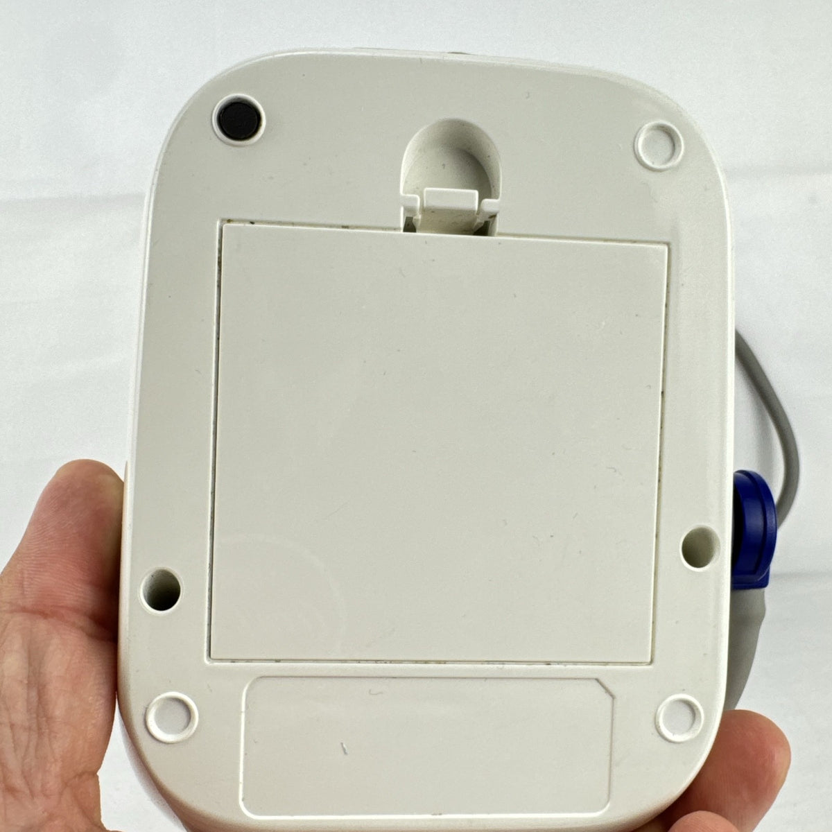White Omron upper arm blood pressure monitor with digital LCD display and adjustable wide fabric cuff