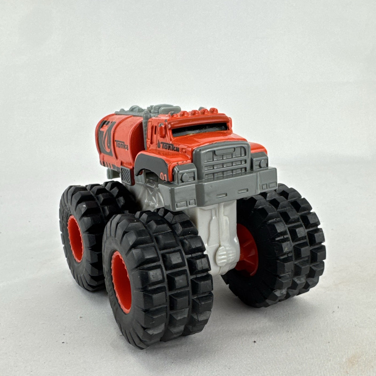 Tonka monster truck 8-wheel dually fuel tanker diecast vehicle in bright orange with flame graphics