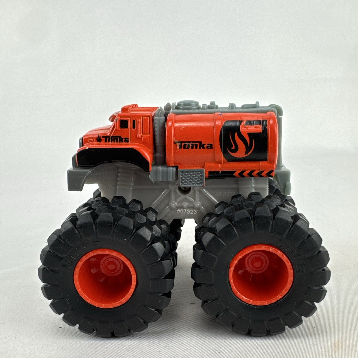 Tonka monster truck 8-wheel dually fuel tanker diecast vehicle in bright orange with flame graphics