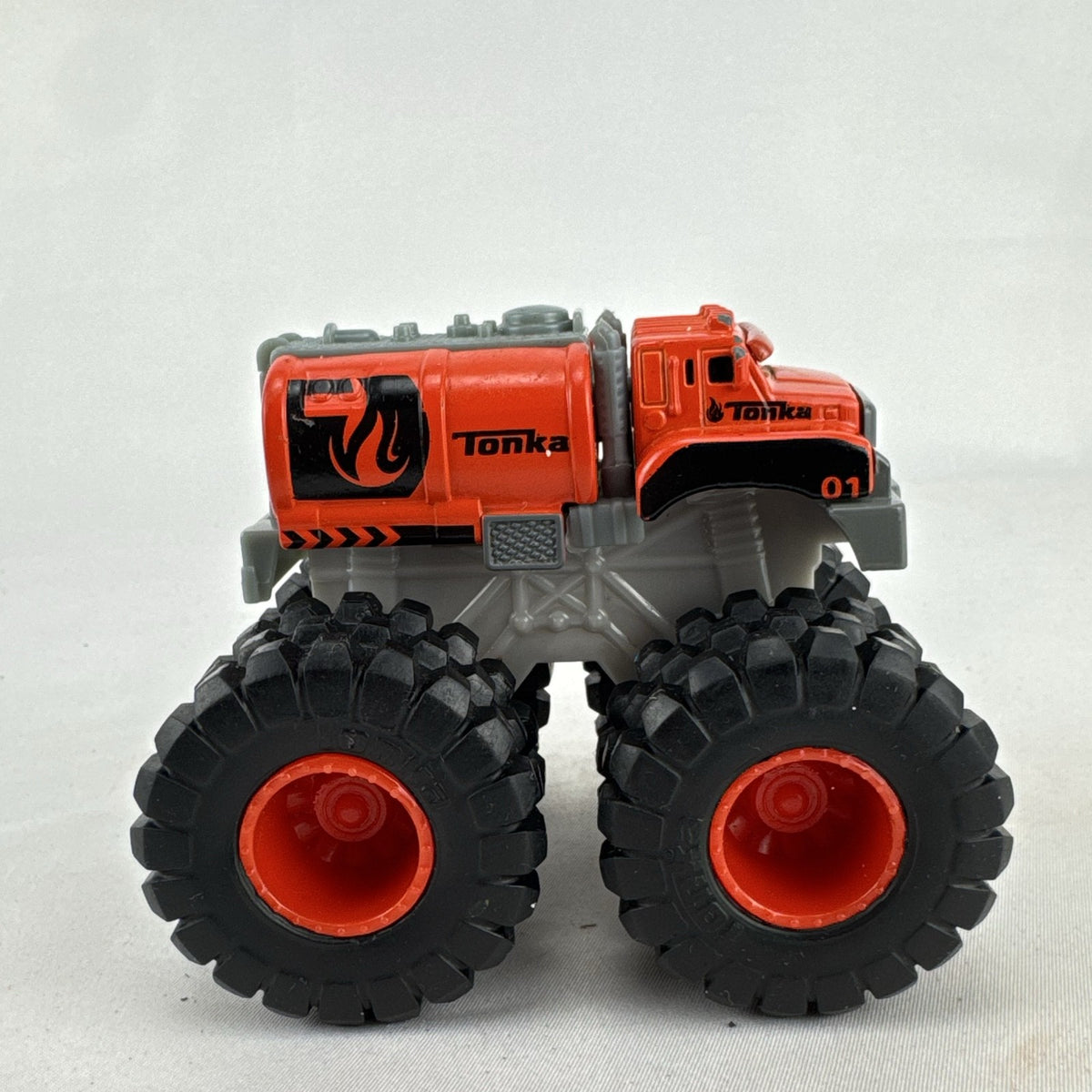 Tonka monster truck 8-wheel dually fuel tanker diecast vehicle in bright orange with flame graphics