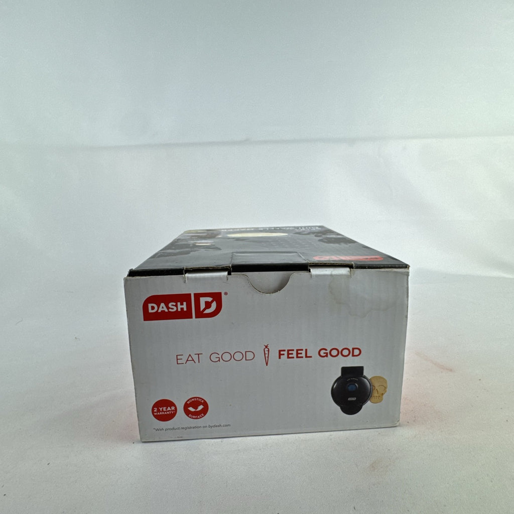 Dash 4-inch black skull mini waffle maker shown with original packaging.