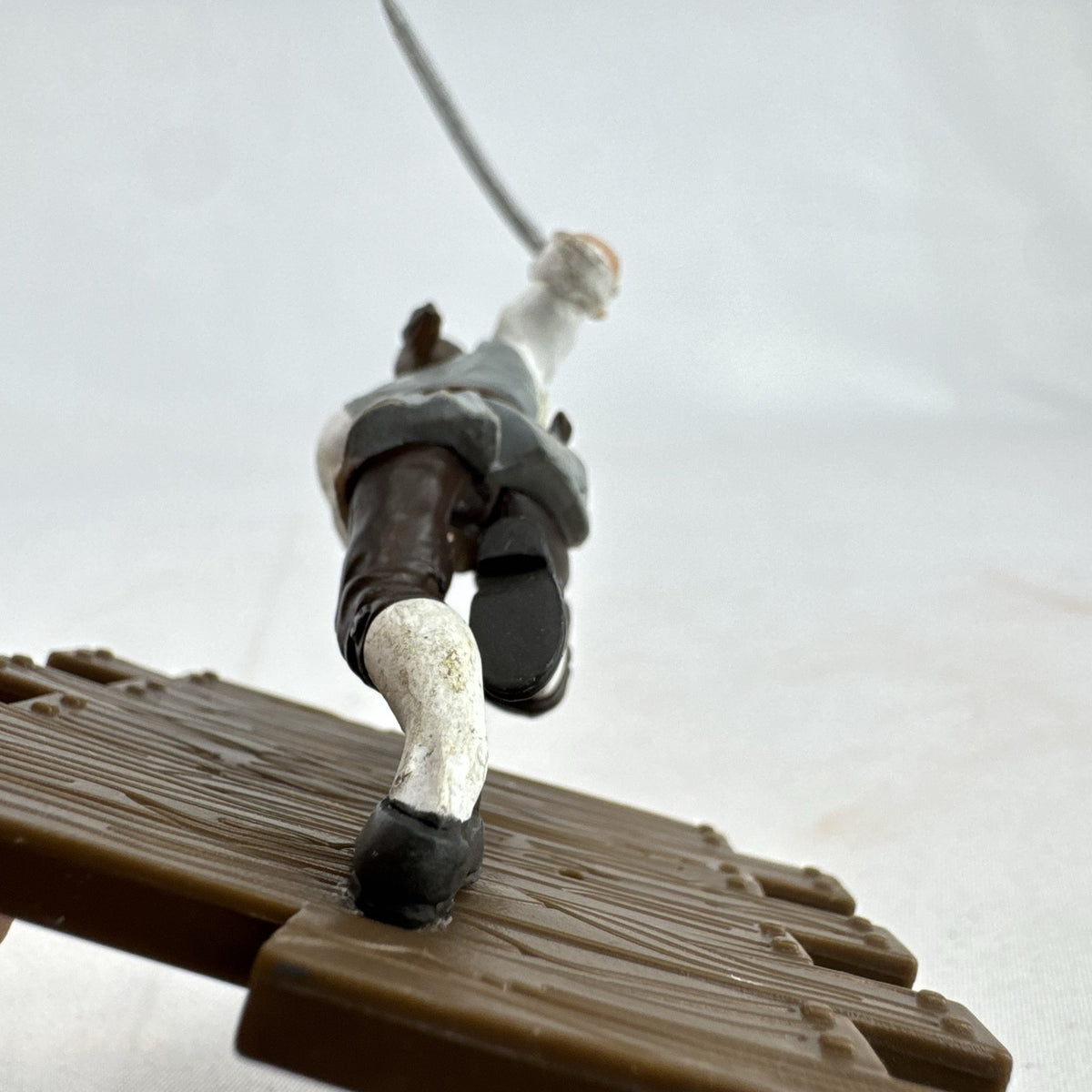 Disney Pirates of the Caribbean Will Turner mini PVC figure with cutlass on wooden dock base