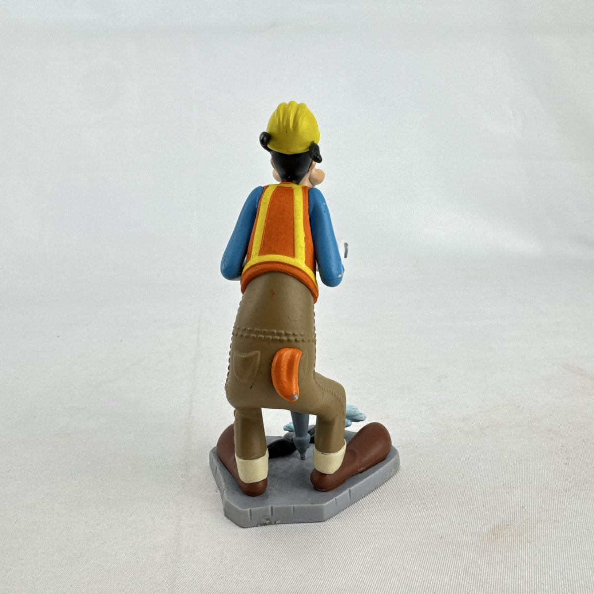 Disney Goofy construction worker PVC figurine holding a jackhammer and wearing a hard hat