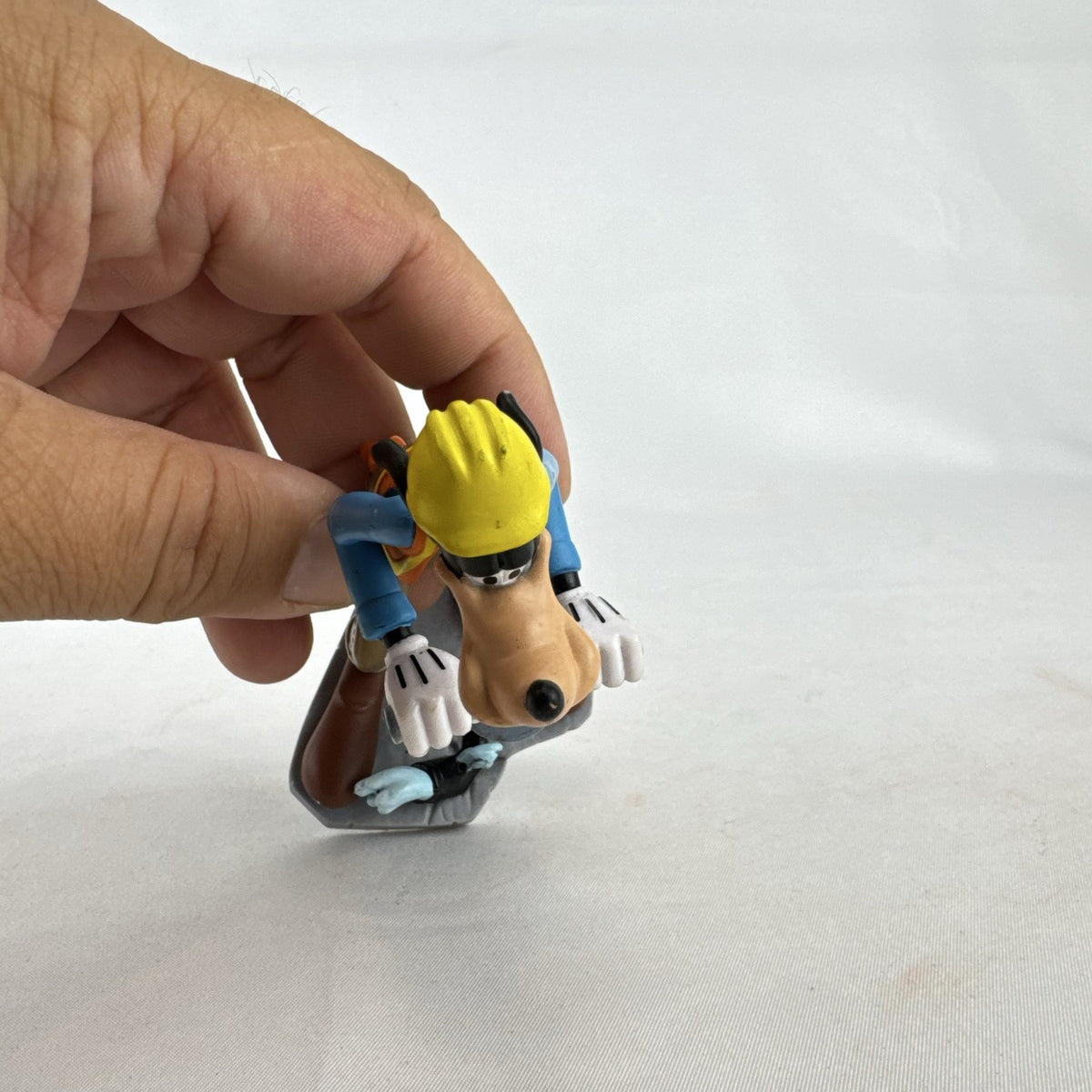 Disney Goofy construction worker PVC figurine holding a jackhammer and wearing a hard hat