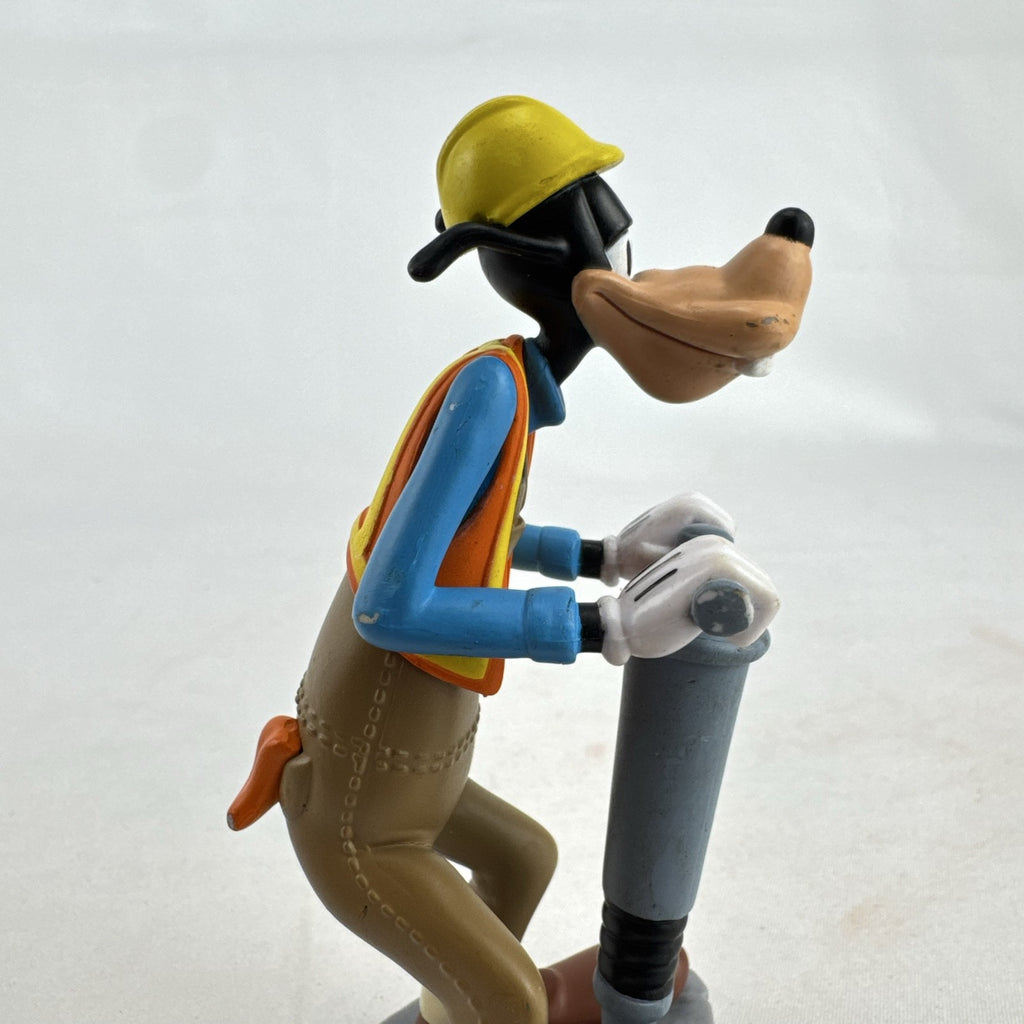 Disney Goofy construction worker PVC figurine holding a jackhammer and wearing a hard hat