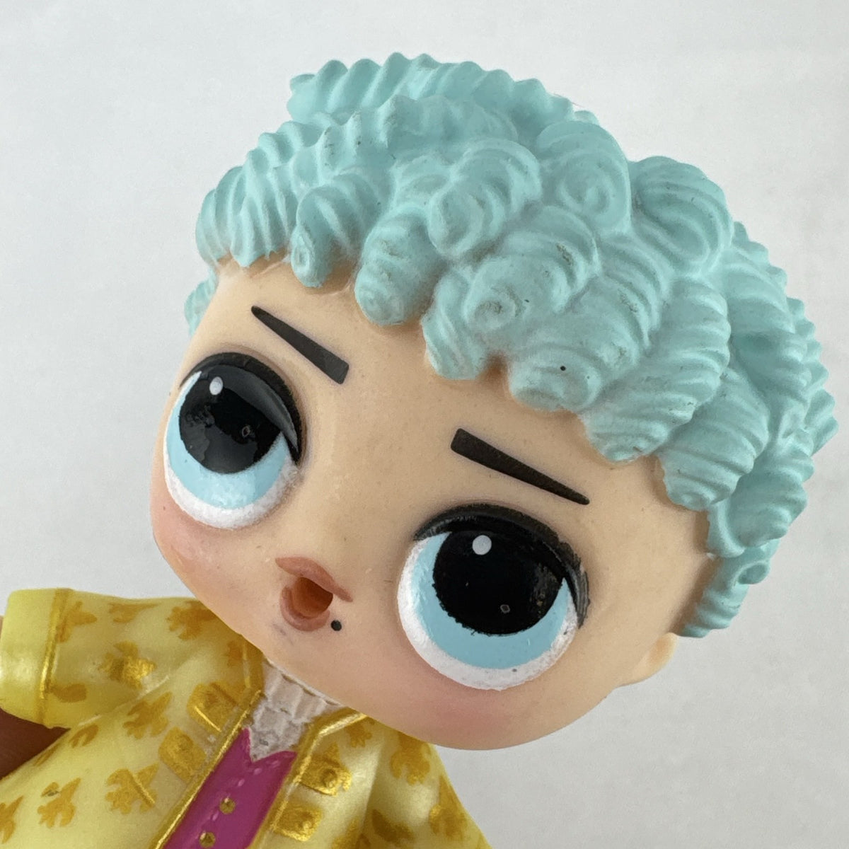 MGA L.O.L. Surprise! Boys Series 1 His Royal Highness 3-inch doll with turquoise curls and gold jacket