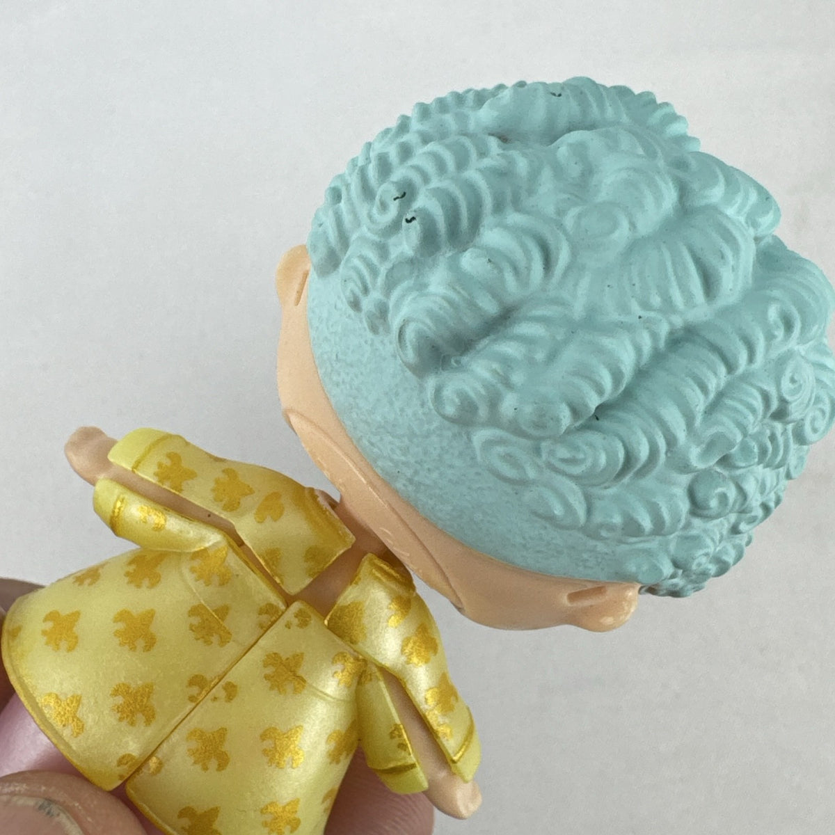MGA L.O.L. Surprise! Boys Series 1 His Royal Highness 3-inch doll with turquoise curls and gold jacket
