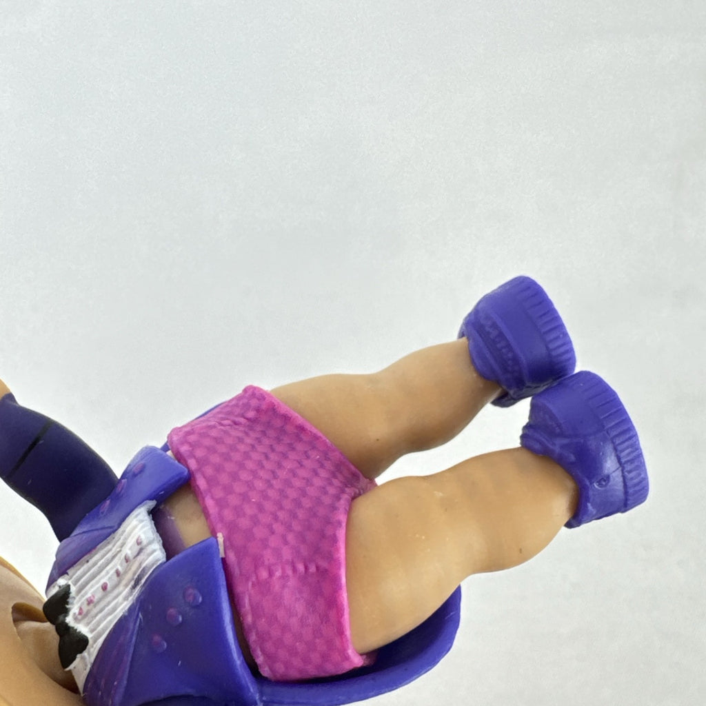 MGA Entertainment L.O.L. Surprise! 3-inch vinyl doll wearing a purple tuxedo suit and red cap