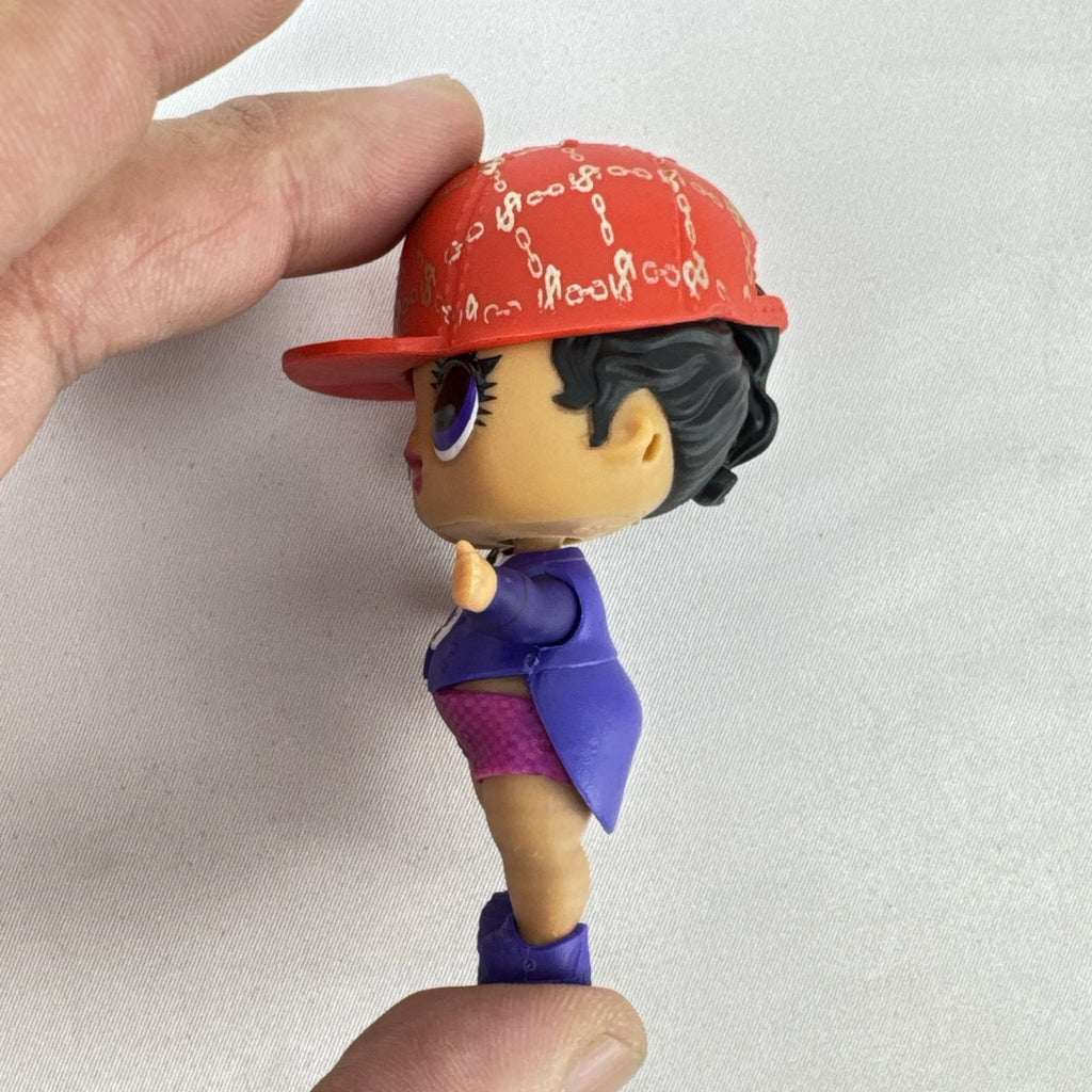 MGA Entertainment L.O.L. Surprise! 3-inch vinyl doll wearing a purple tuxedo suit and red cap