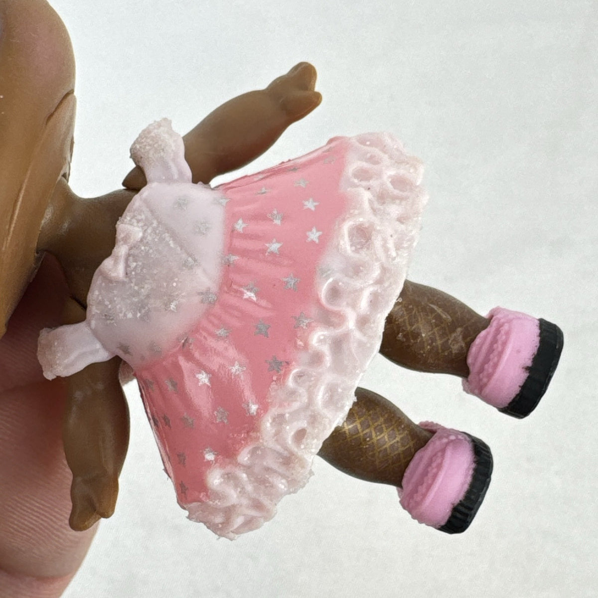 MGA Entertainment L.O.L. Surprise Glitter Series Queen Bee doll with gold glitter hair buns, pink dress, and shoes