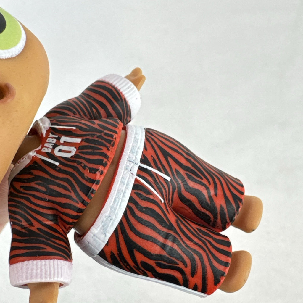 MGA L.O.L. Surprise Boys Swaggy 3-inch mini doll with blonde flocked hair and red tracksuit.