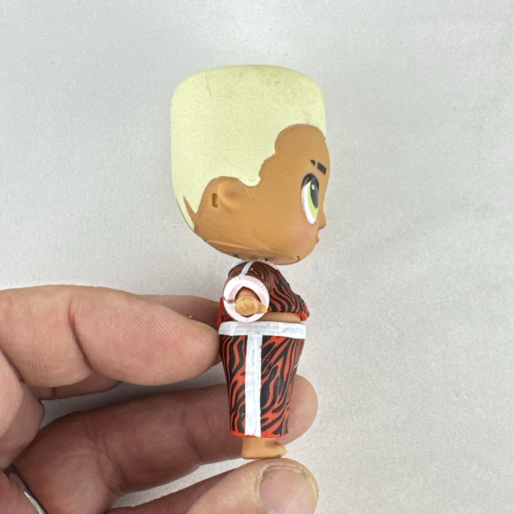 MGA L.O.L. Surprise Boys Swaggy 3-inch mini doll with blonde flocked hair and red tracksuit.