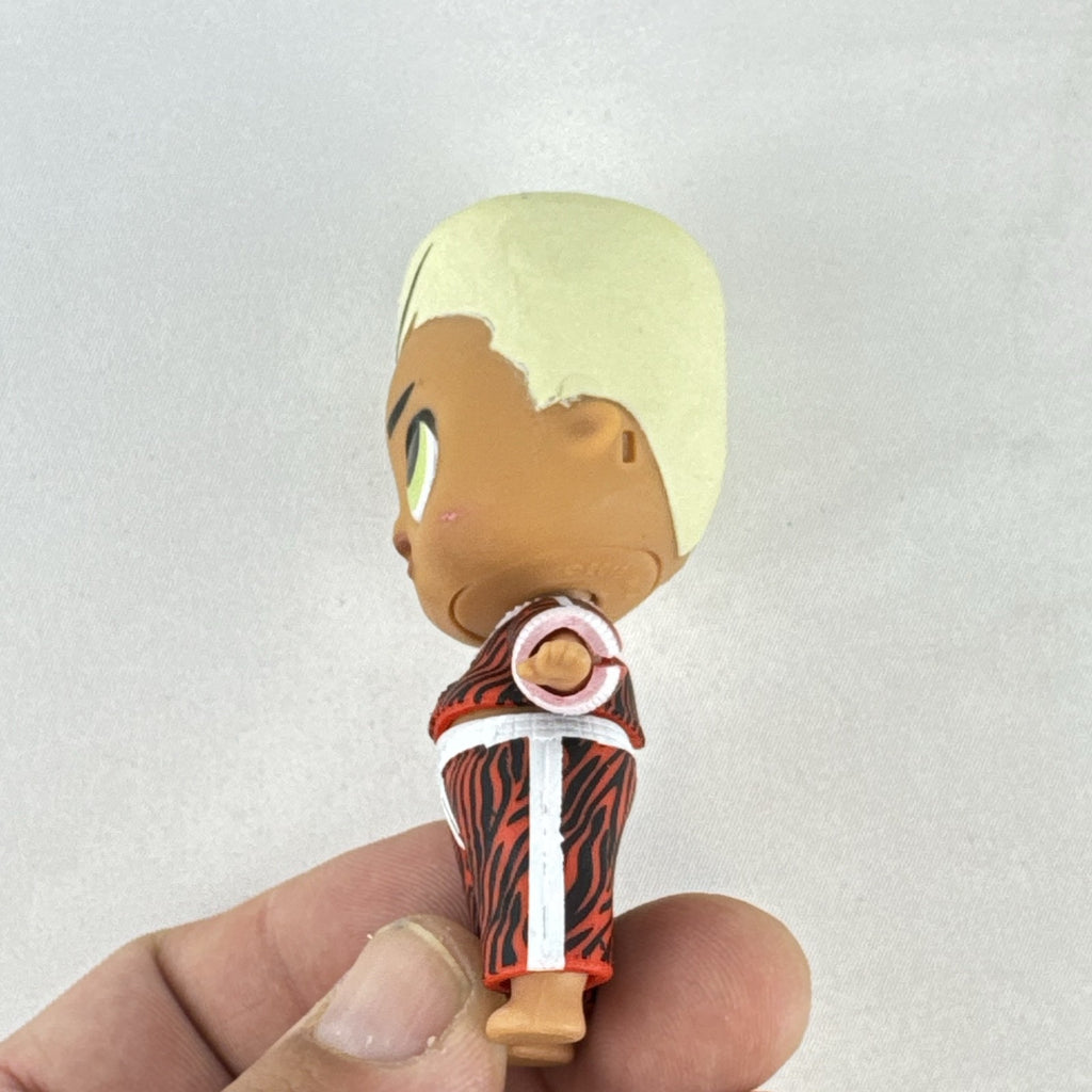 MGA L.O.L. Surprise Boys Swaggy 3-inch mini doll with blonde flocked hair and red tracksuit.